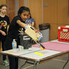 Girls competing in MESA competition with mechanical arm